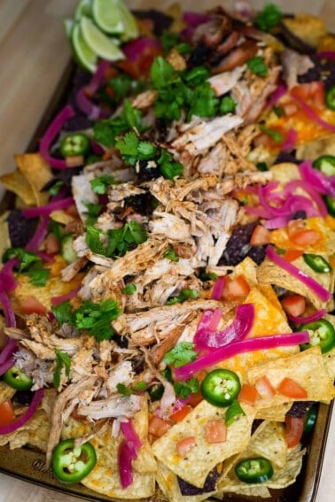 Pulled Pork Nachos with all the toppings and ready to eat!