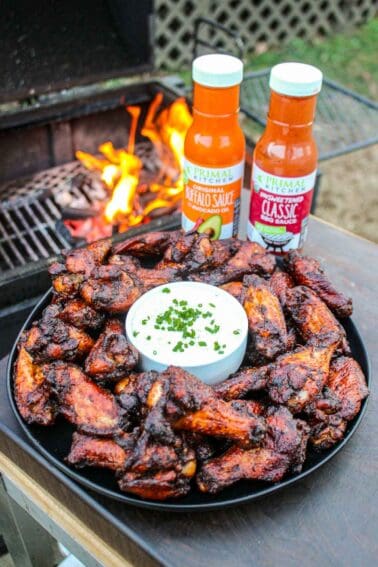 Smoked and twice fried chicken wings seasoned with Primal Kitchen BBQ Sauce and Buffalo Sauce is foodie heaven.