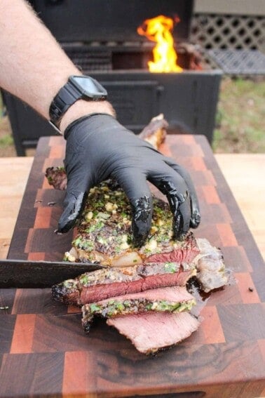 Slicing into the grilled ribeye with cowboy butter.