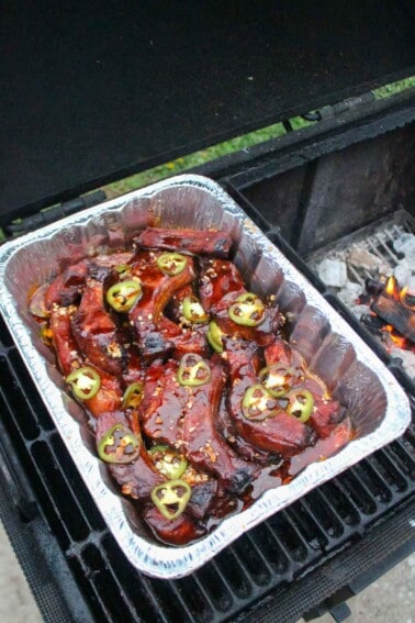 Honey fire party ribs in the crutch on the smoker.