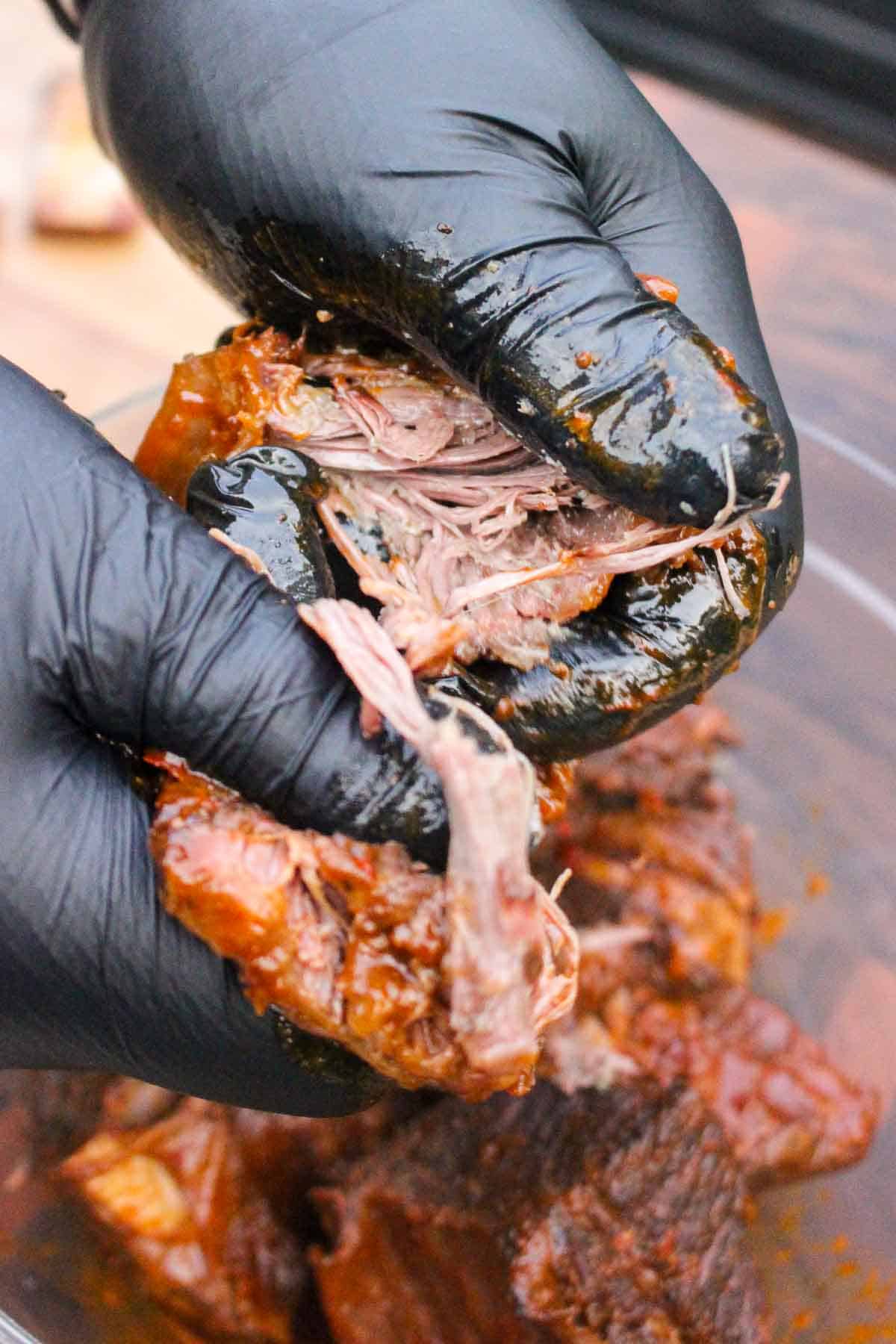Pulling the beef from the short ribs after braising.