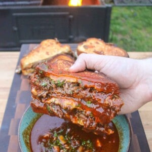 A Birria Grilled Cheese Sandwich after being dipped in the consomme.