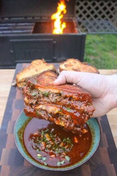 A Birria Grilled Cheese Sandwich after being dipped in the consomme.