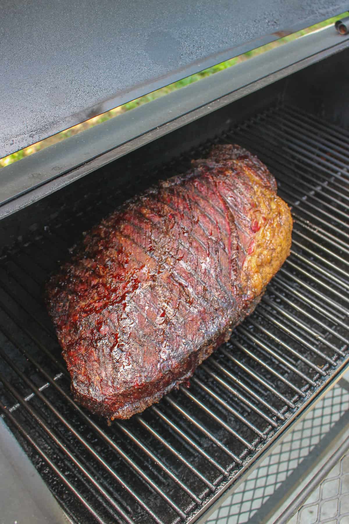 The beef cooking on the smoker.