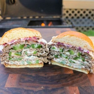 A sliced Jalapeño Popper Smash Burger so that you can see the inside.