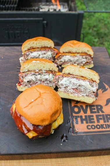 The bacon jalapeño popper stuffed burger sliced so you can see the popper filling inside.