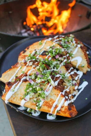Crispy BBQ Pulled Pork Tacos garnished and sitting on a serving platter.