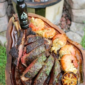 Grilled Steak and Shrimp with BLK Garlic Butter assembled on a cutting board and ready to serve.