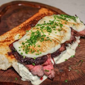 The Peter Luger Steak Sandwich assembled and ready to slice before serving.
