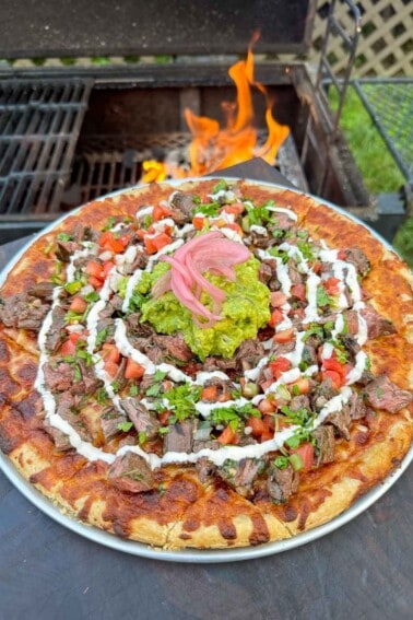 Carne Asada Pizza assembled and ready for slicing.