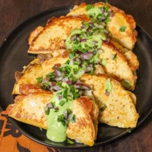 Crispy Steak and Shrimp Tacos served on a plate.