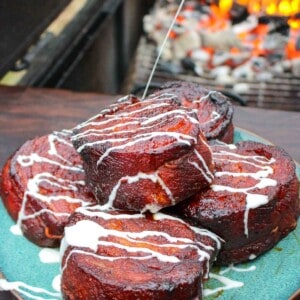 Pork Belly Cinnamon Rolls getting iced before serving.