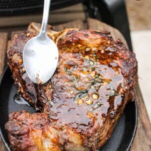 Basting the steaks with the herb tallow.