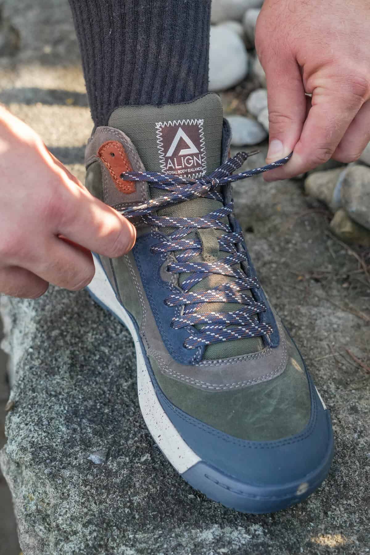 Close up of Derek Wolf lacing up his Align shoe.