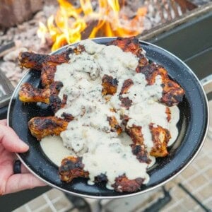 The plate of Butterflied drumsticks is ready and smothered in our homemade queso.