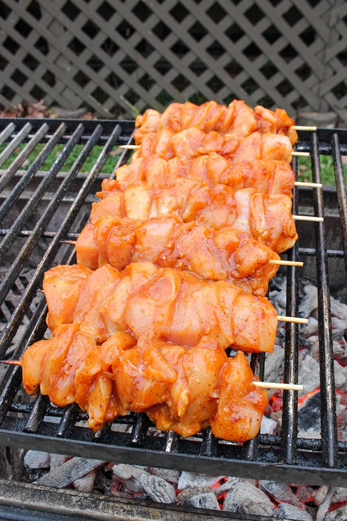 Seasoned Hawaiian chicken skewers on the grill