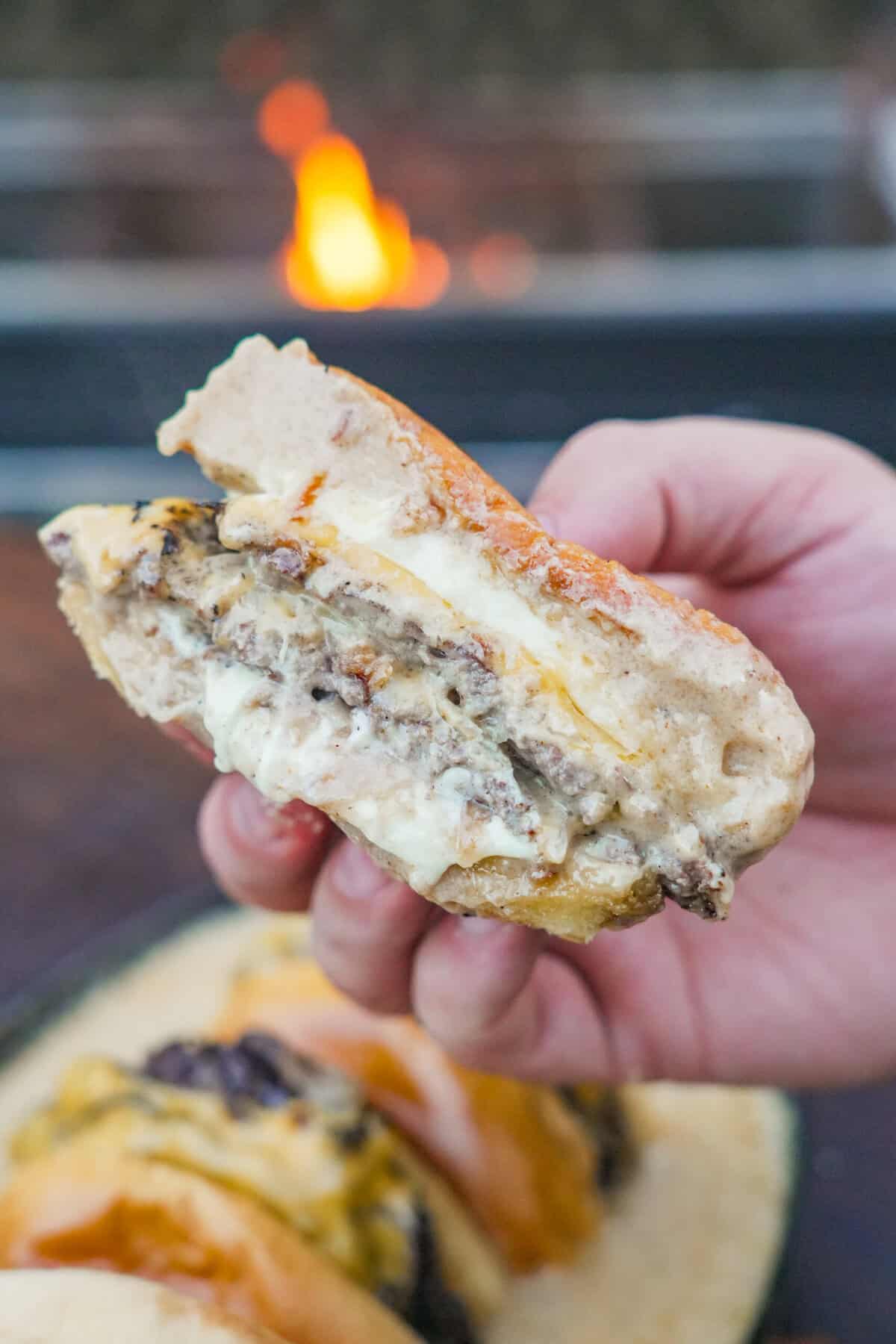A close up of the cheesy burger, a mouthwateringly delicious bite.