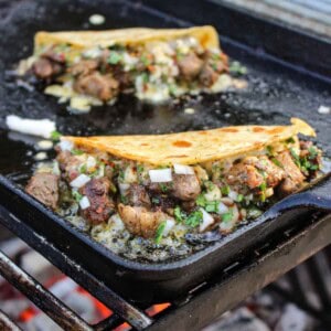 The Steak Bite Tacos on a sizzling griddle.