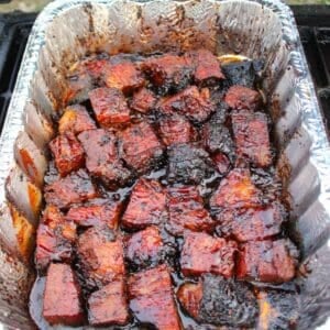 BBQ Burnt Ends in a foil container.