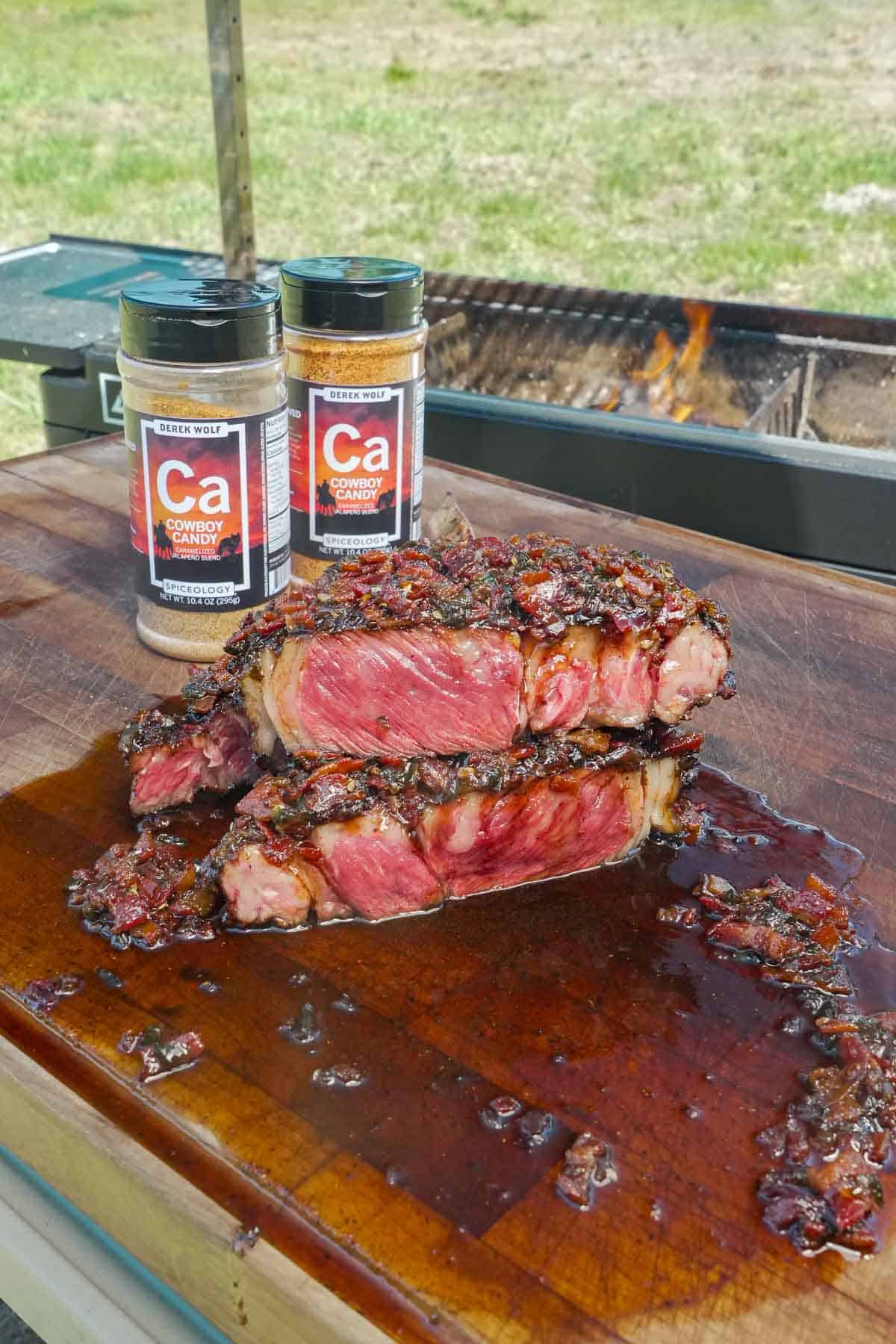 The Cowboy Candy Rubbed Grilled Steak with Bacon Jam is cooked, sliced, and ready to devour.