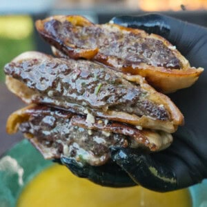 A close-up of the Cowboy Butter Arayes in the hands of Derek Wolf, juicy and tasty looking.