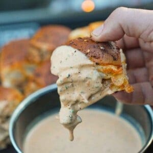 A hot honey chicken slider is dipped in our spicy ranch dressing.