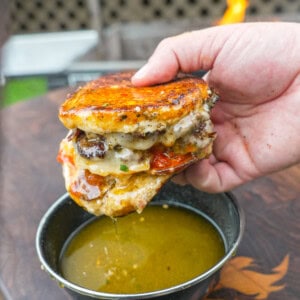 Dipping the pizza smashburger in garlic Parmesan butter