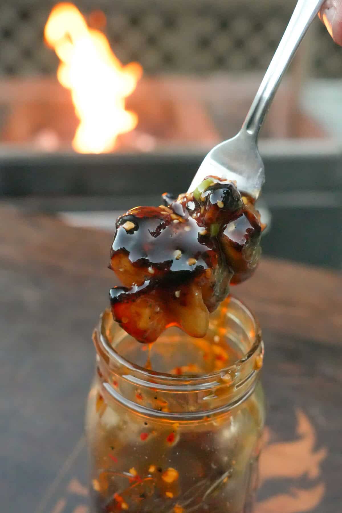 Dipping a forkful of chicken in the teriyaki sauce