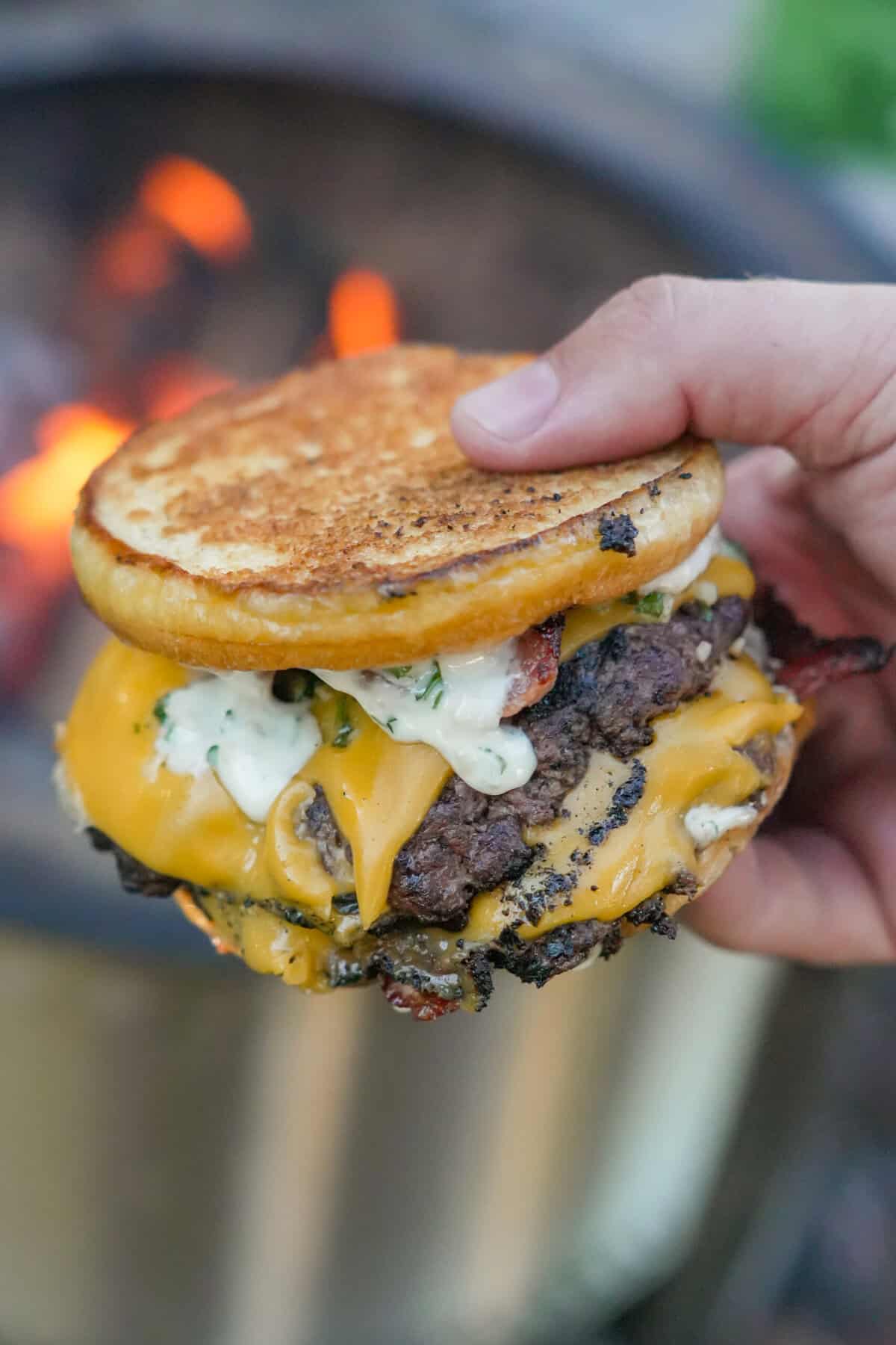 The toasted bread is the perfect complement to the perfectly cooked 80/20 beef, American cheese, and homemade aioli sauce.