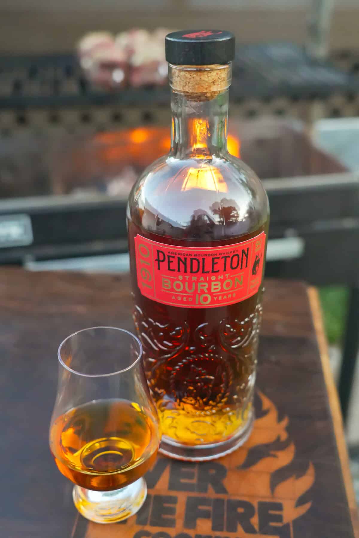 A glass of Pendleton Whisky is poured next to the nearly full bottle.