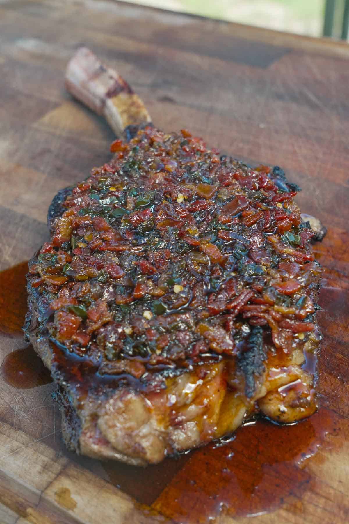 The bacon jam is slathered over the steak - smoky char, sweetness, and tender steak awaits!