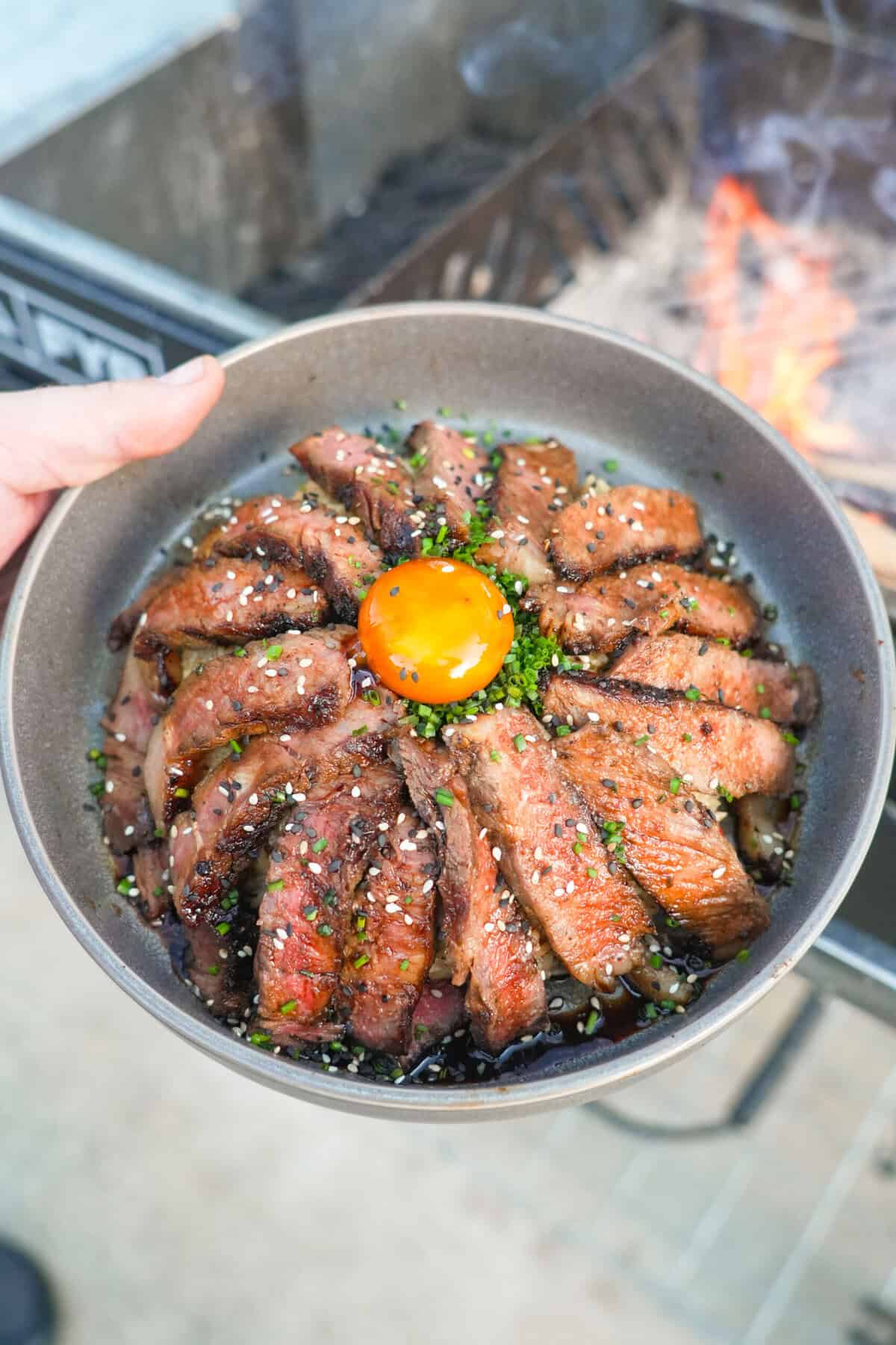 Overhead shot of the Steak Rice Bowl with the egg yolk in the center, surrounded by steak slices over rice.