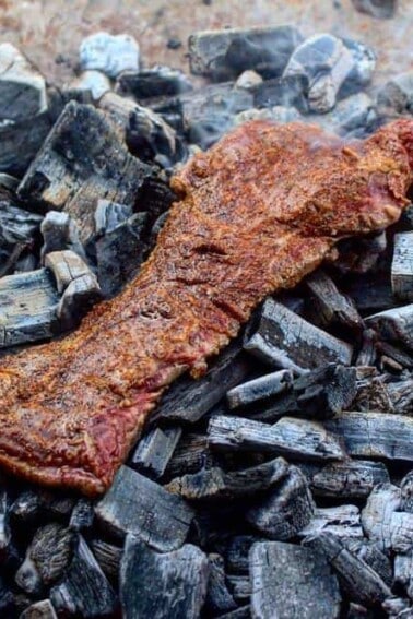 steak sitting on the coals