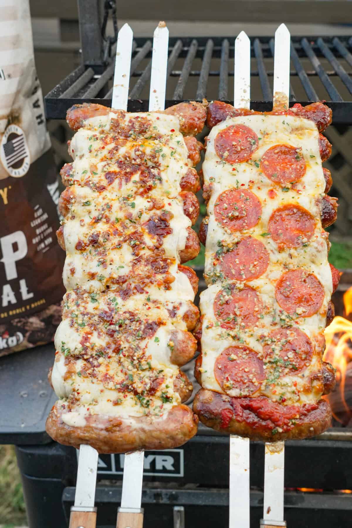 Two preparations of pizza sausage skewers: the first with alfredo sauce, bacon bits and Buffalo sauce, and the second on the right with pepperoni slices, mozzarella cheese and marinara sauce