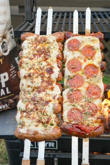 Two preparations of pizza sausage skewers: the first with alfredo sauce, bacon bits and Buffalo sauce, and the second on the right with pepperoni slices, mozzarella cheese and marinara sauce