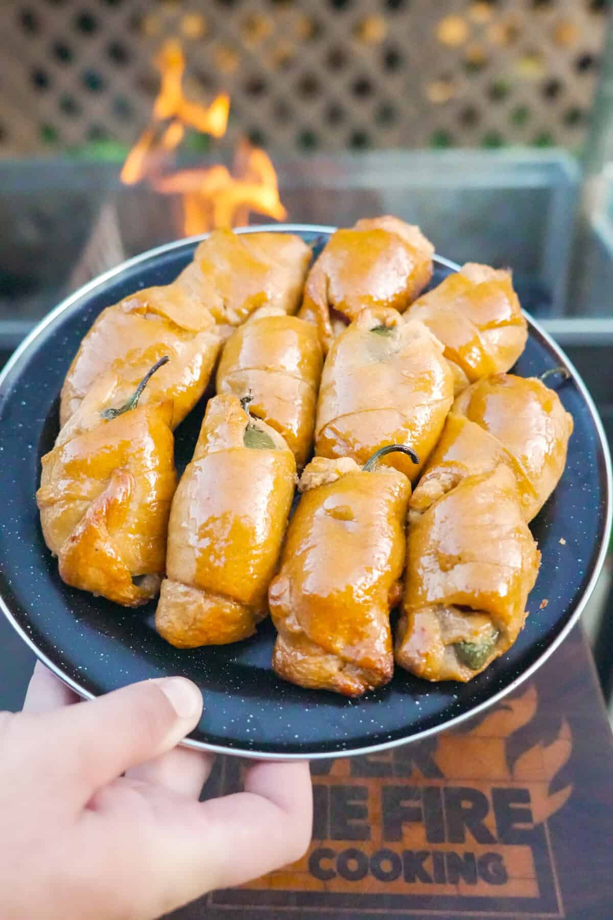 A plate of jalapeño popper pigs in a blanket, golden brown and crispy