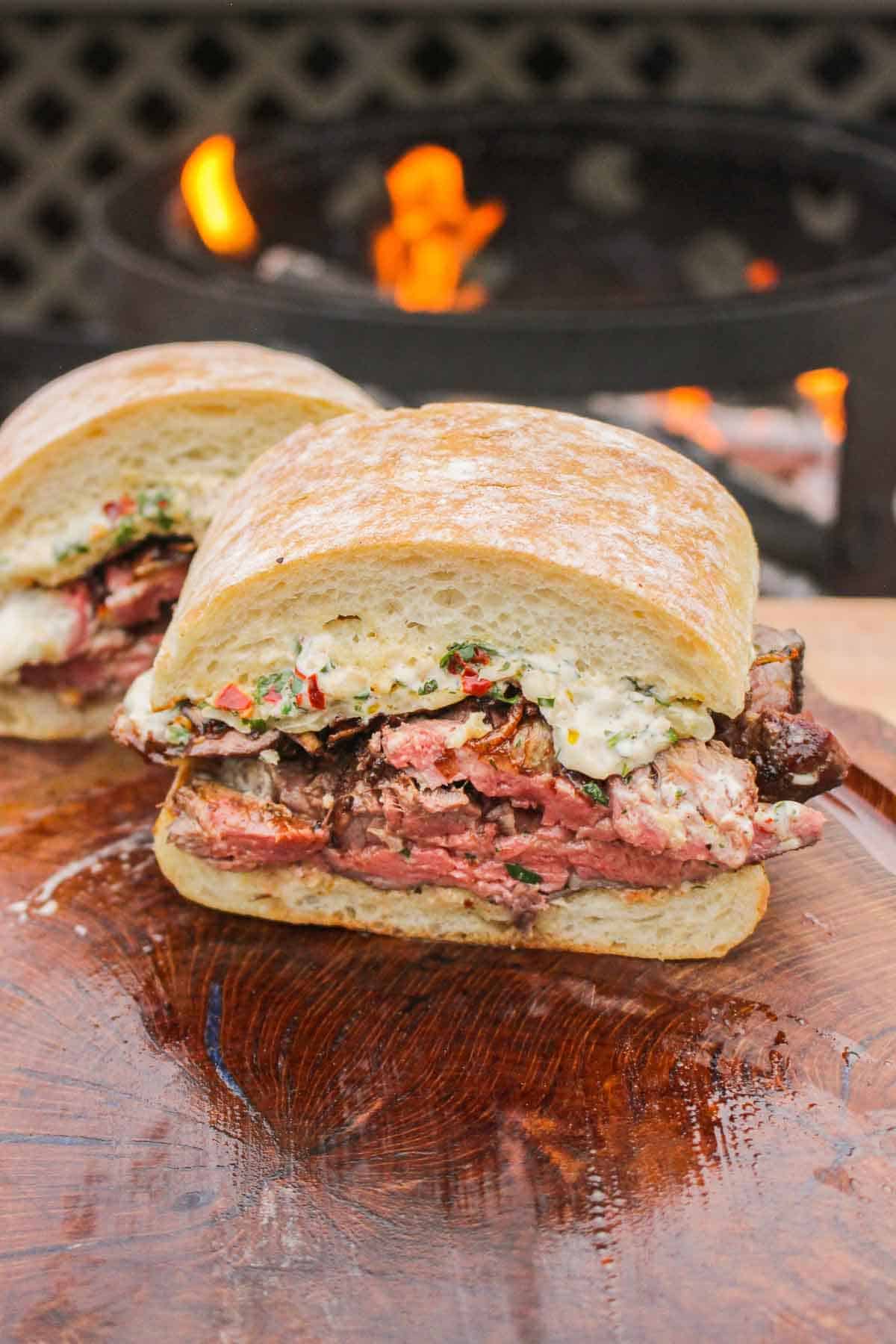 Half of a chimichurri steak sandwich so you can see the layers on the inside. 
