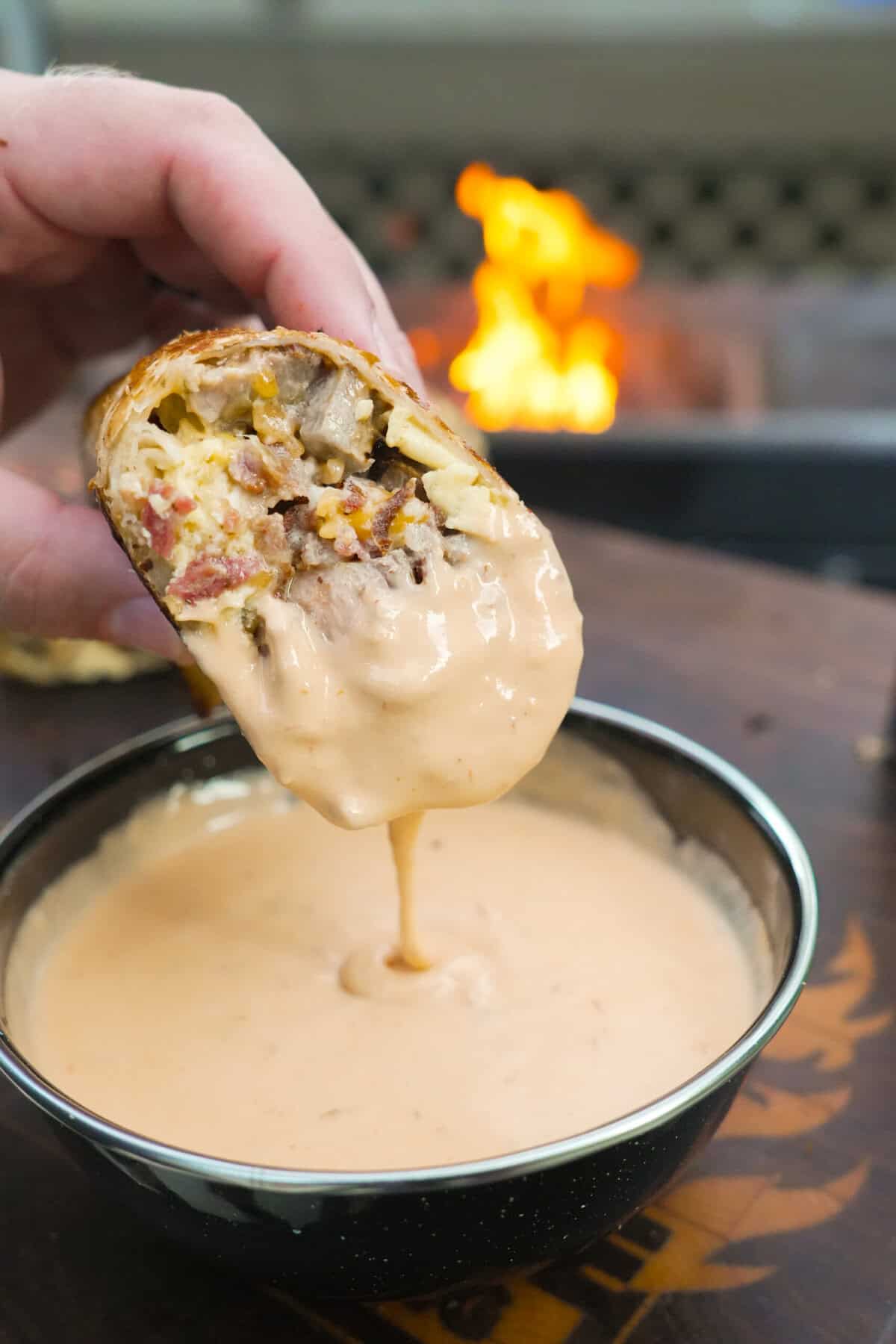 Dipping the steak breakfast burrito in Queso. 