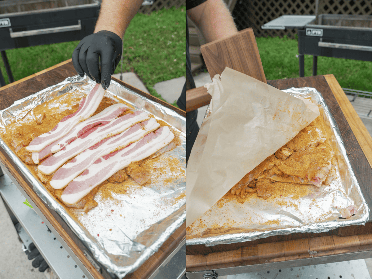 Pounding boneless chicken thighs with a mallet into a thin layer, inside a foil lined baking sheet with parchment paper on top, then a gloved hand adding a layer of bacon on top of the chicken