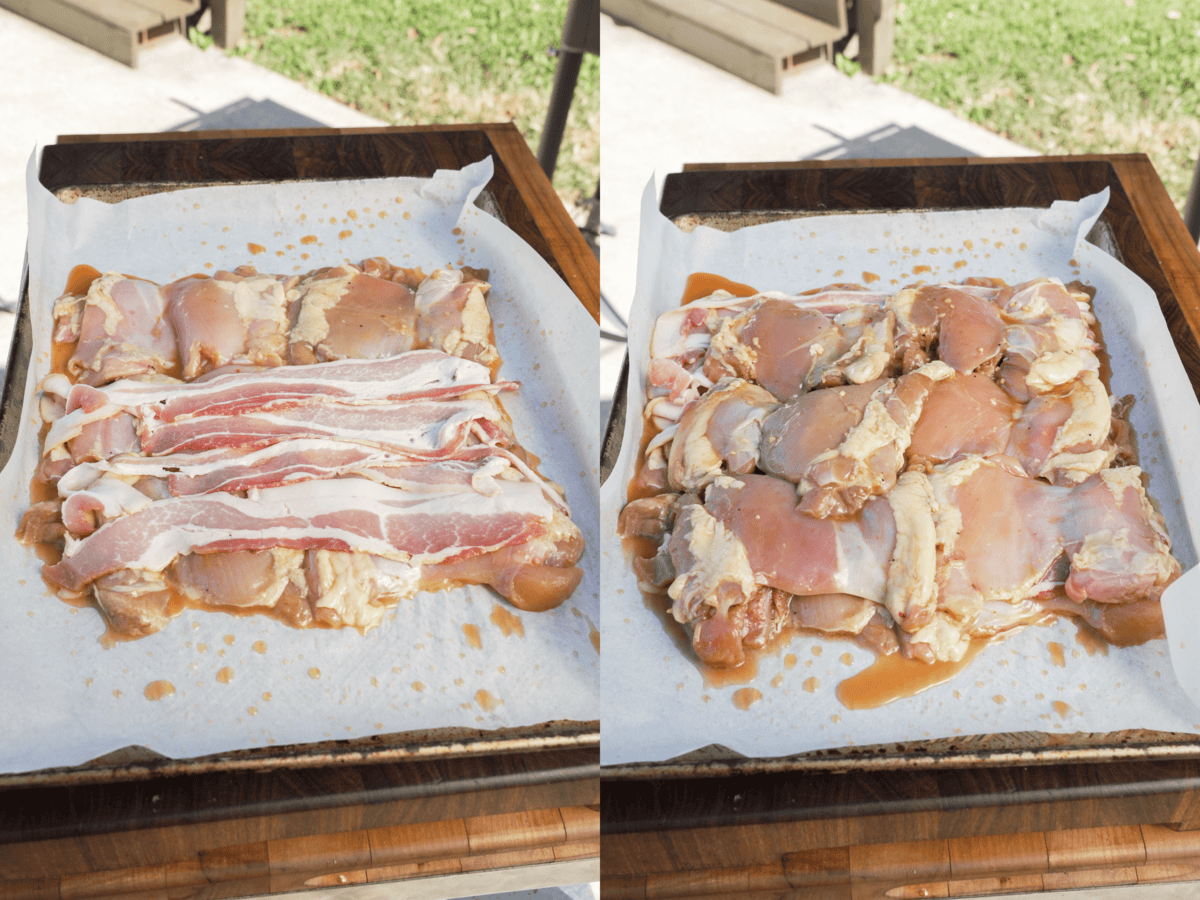 Assembling boneless chicken thighs and slices of bacon into a layers on a parchment paper lined baking sheet