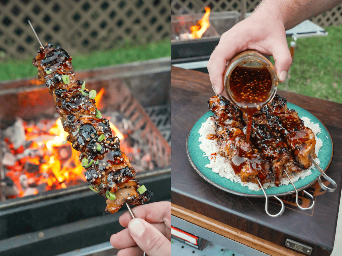 Holding up a finished teriyaki chicken skewer with the fire in the background and pouring extra teriyaki sauce over the skewers and rice