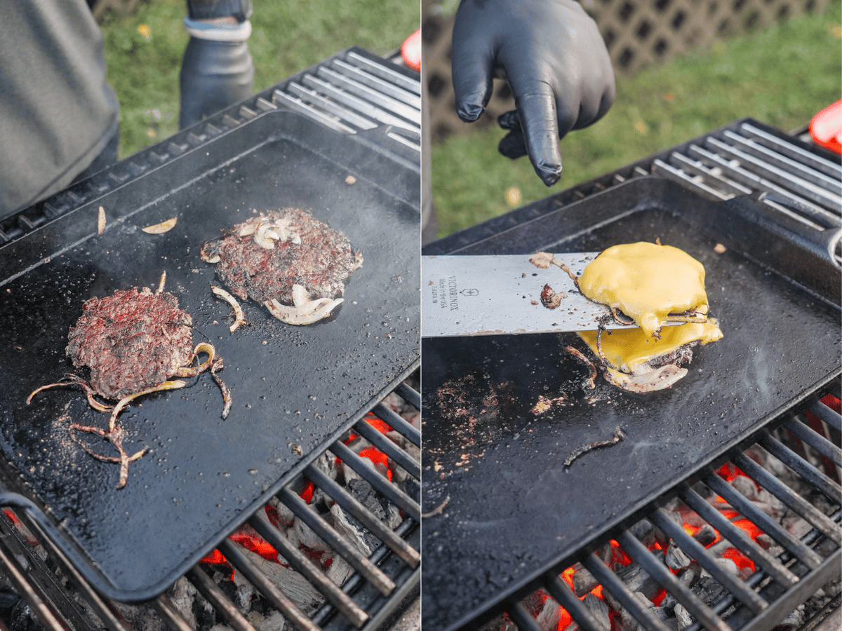 The burgers are flipped on the grill and layered with American cheese - a classic.