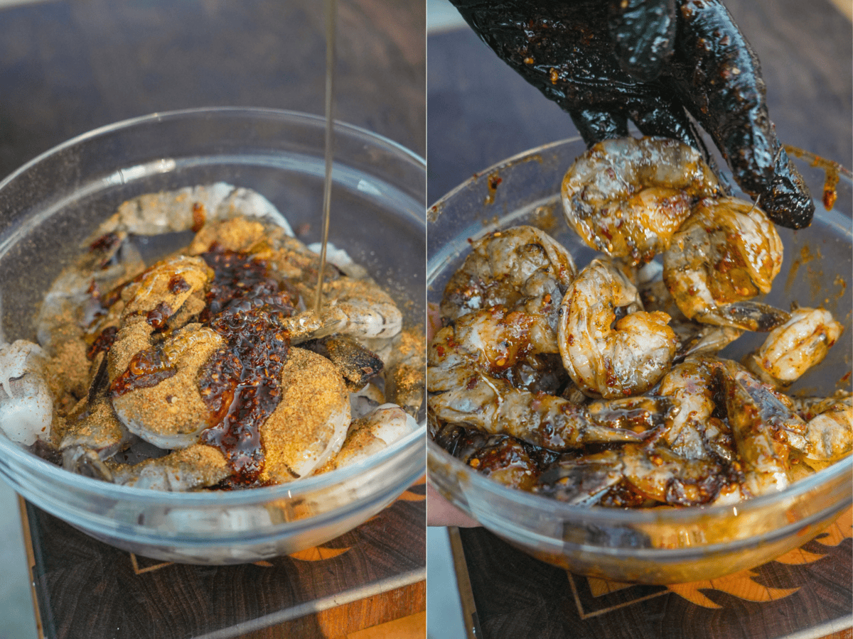 Seasoning raw shrimp in a bowl with Cowboy Butter Rub, chili oil and honey