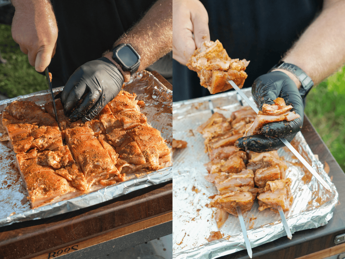 Slicing the chicken and bacon into 2x2 inch cubes with a sharp knife, then threading the meat cubes onto metal skewers