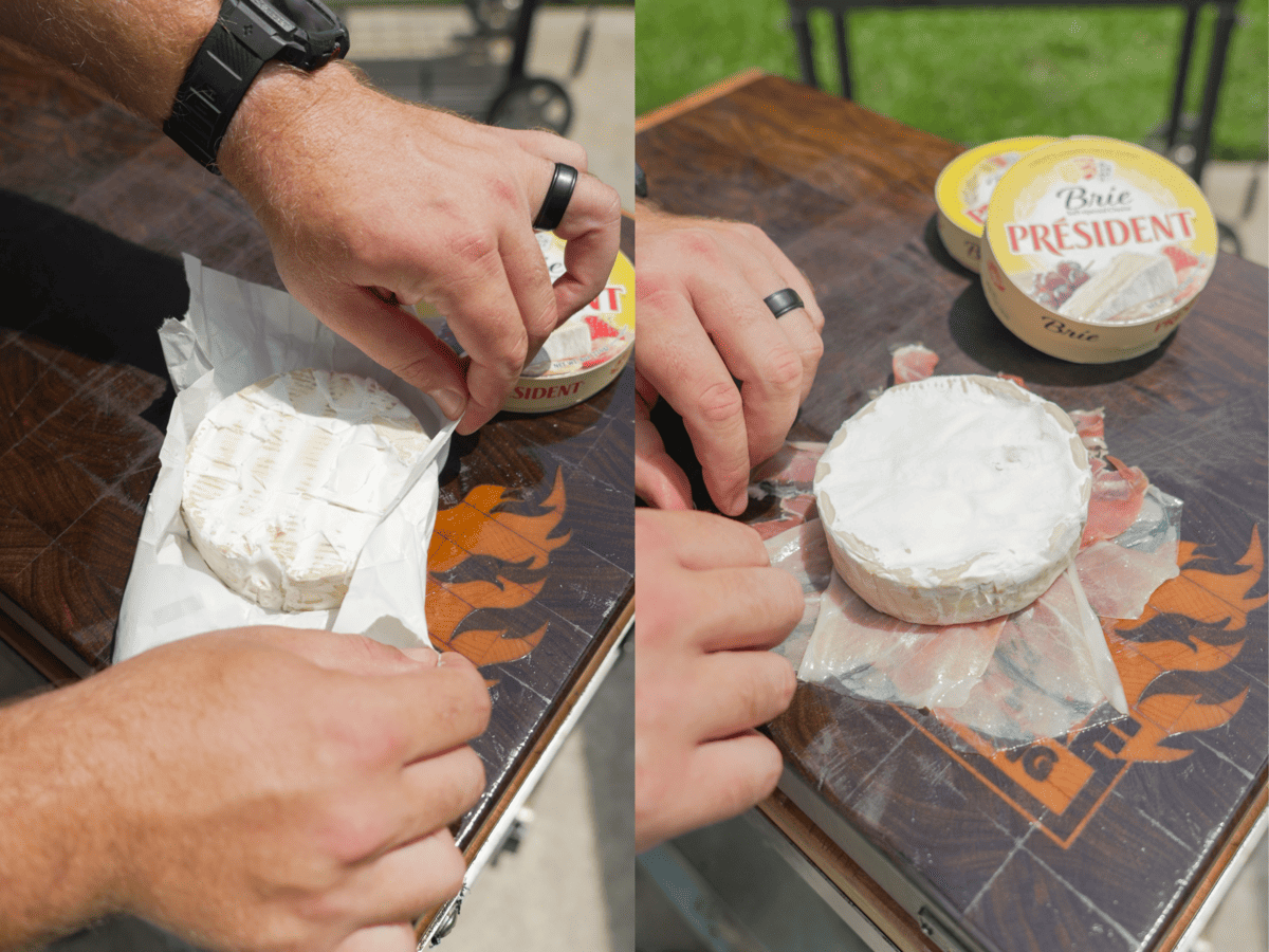 Unwrapping a wheel of brie out of the box, then rewrapping with slices of prosciutto